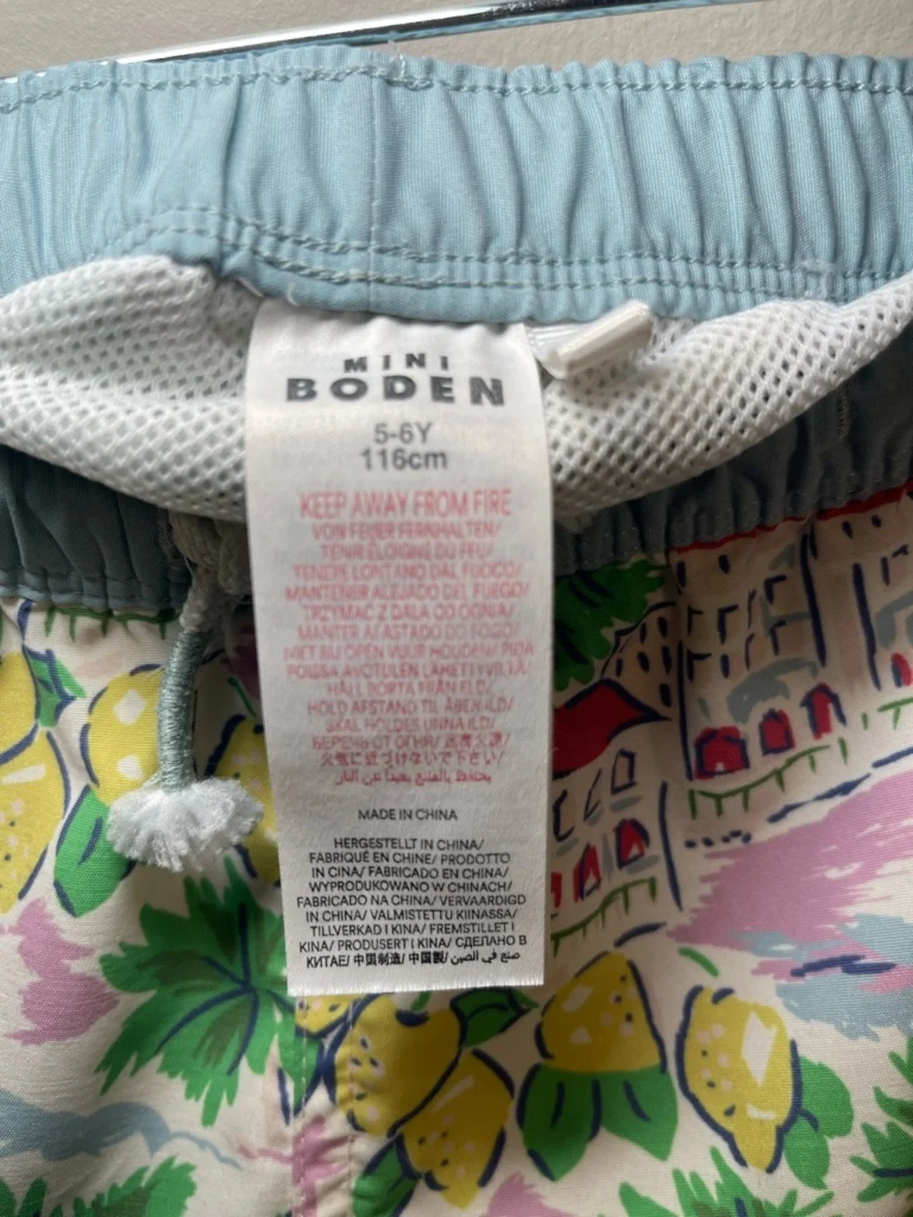 Mini Boden Pastel Coastal Print Swim Shorts in Light Blue, Yellow & Green